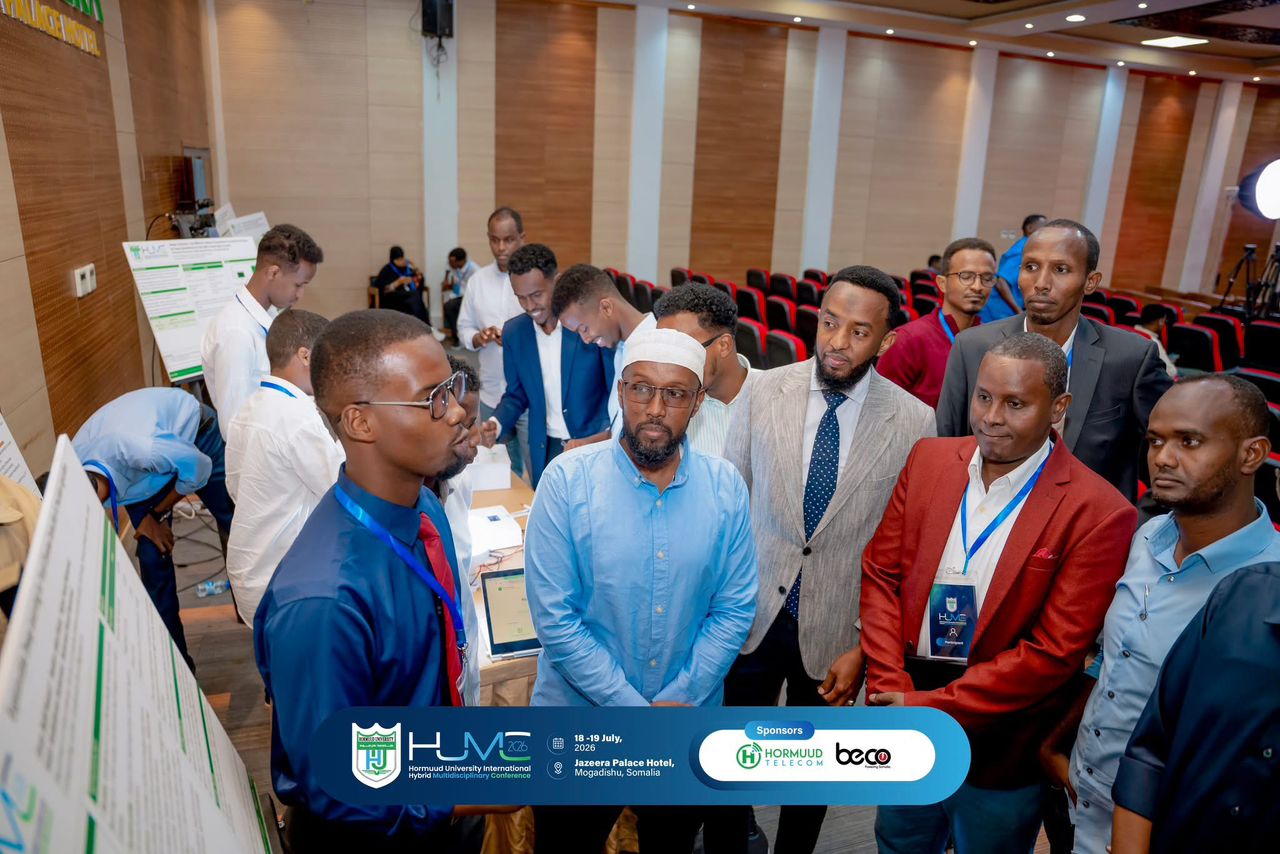 Participants discussing a research poster at HUMC
