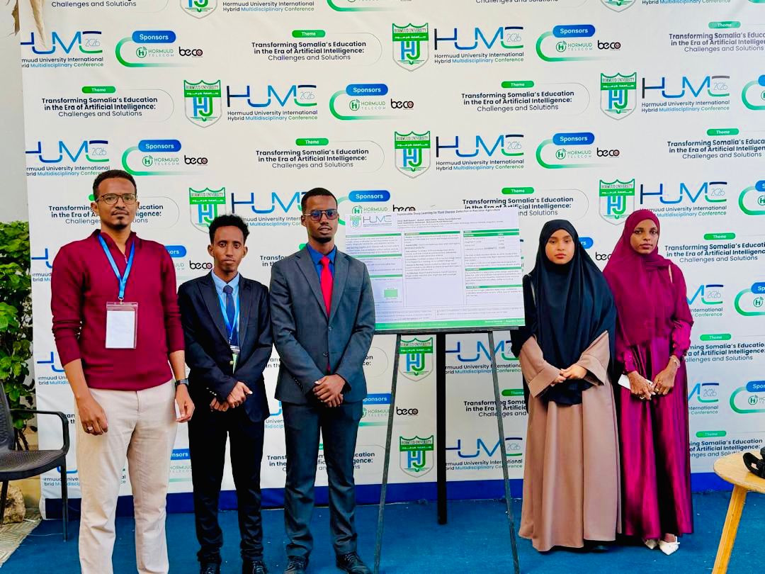 Five participants standing beside a research poster at HUMC