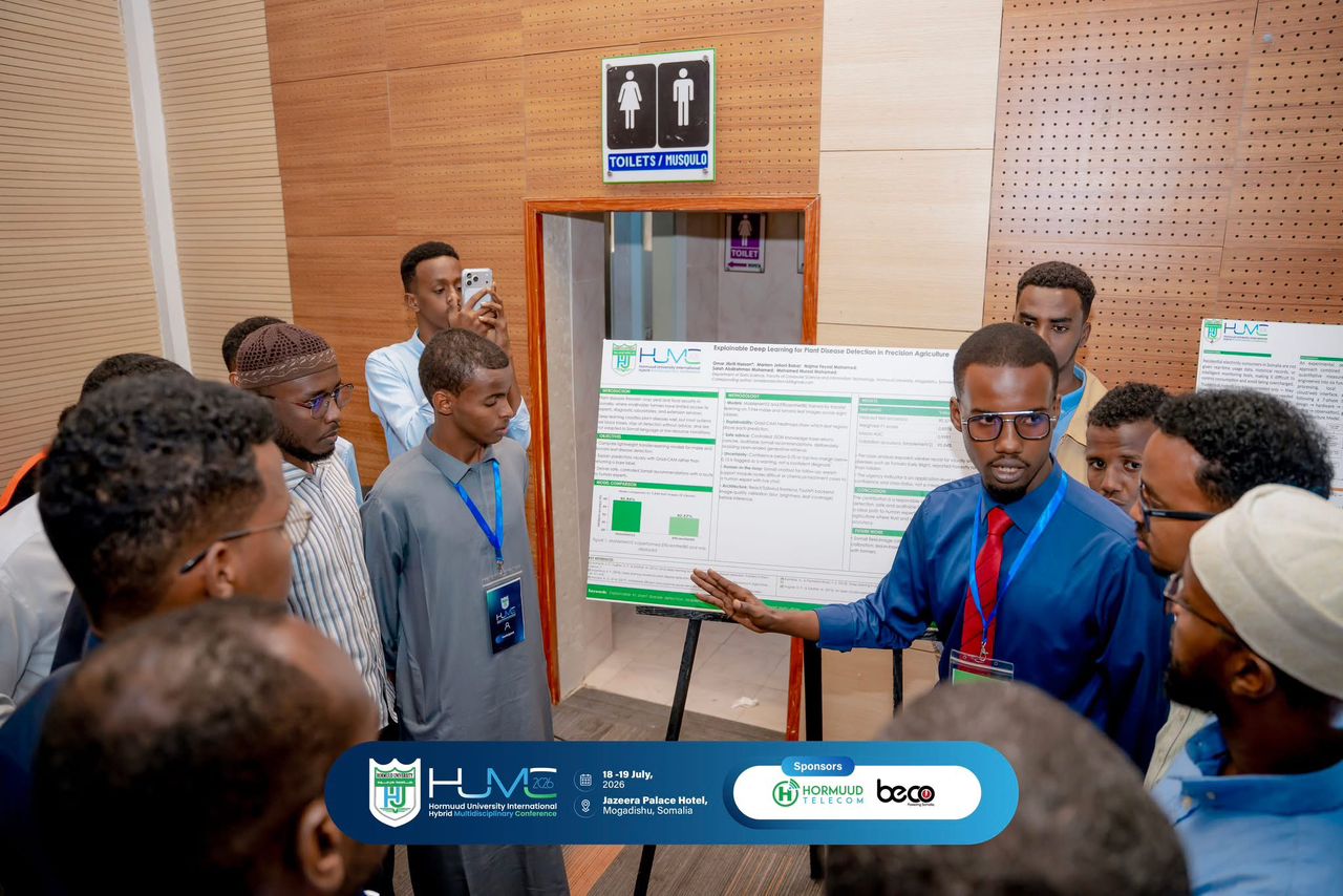 A presenter explaining a research poster at HUMC